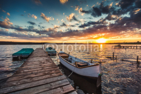 Fototapety Peaceful sunset with dramatic sky and boats and a jetty