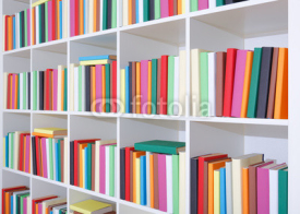 Books on a white shelf, stack of colorful books in Library