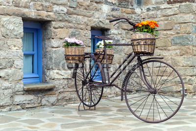Rusty bicycle in front of a traditional house in Epirus, Greece