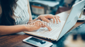  woman's hands busy working on her laptop
