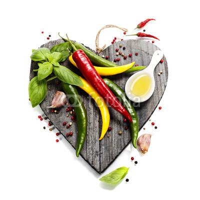 Fresh vegetables on heart shaped cutting board