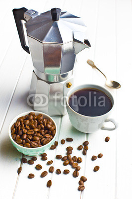 coffee maker with cup of coffee and coffee beans