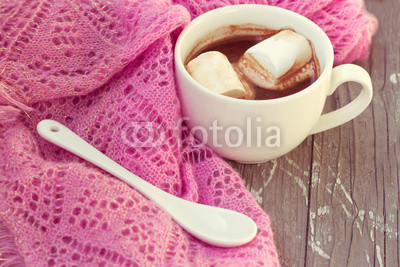 cup of hot chocolate wrapped in a scarf