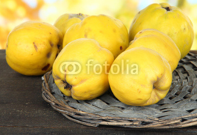 Sweet quinces on table on bright background
