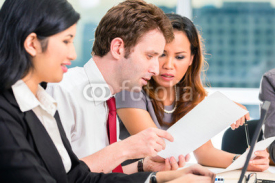 Fototapety Asian Businesspeople having meeting in office