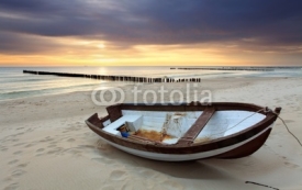 Fototapety Boat on beautiful beach in sunrise