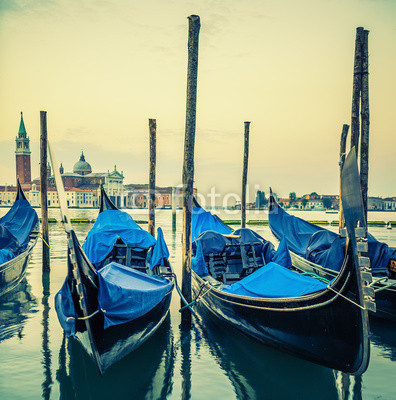 Gondolas floating in the Grand Canal at sunset