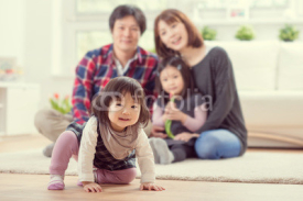Young happy family with pretty daughters playing and having fun