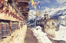 Fototapety Prayer wheels in high Himalaya Mountains, Nepal village, tourism travel destination