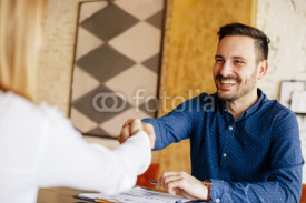 Businessman and businesswoman handshake