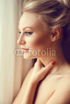 Naklejki Emotive portrait of young beautiful woman with long blonde hair.
