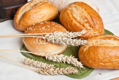 Freshly baked traditional rolls with ears of wheat grain