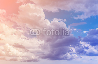 White clouds with blue sky background. Color toned image.