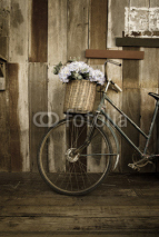 Naklejki Old ladies bicycle leaning against a wooden plank