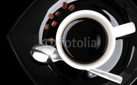 Fototapety Coffee in white cup on black saucer,  top view