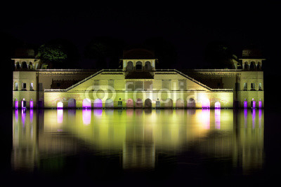 Night photo of a castle in India reflecting in the lake