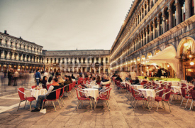 VENICE, ITALY - MAR 23, 2014: Tourists enjoy cafe in Piazza San