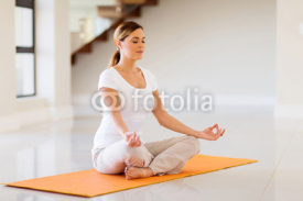 Naklejki young woman doing yoga exercise