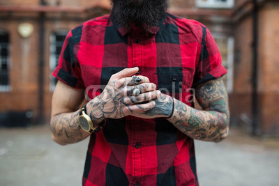 Hands close up of young tattooed man portrait in Shoreditch. London.