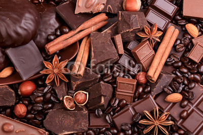 Background from slices of chocolate, coffee, nuts and spices
