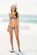 Fototapety Young woman wearing flippers at the beach