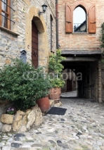 Fototapety Old terraced houses on cobbled alleyway, Castell'Arquato
