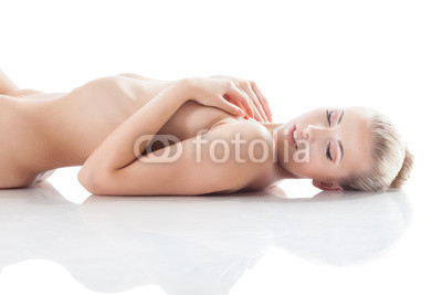 Portrait of smiling girl lying naked in studio