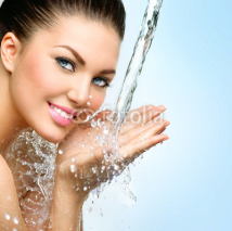 Naklejki Beautiful smiling girl under splash of water