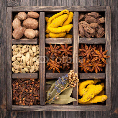 Assorted colorful spices in an old wooden box