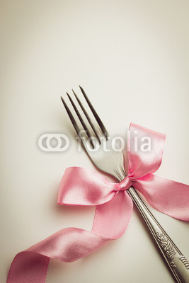 Fork with decorative ribbon.