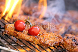 Naklejki Flame grilled steaks on the grill chilli red