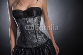 Close-up shot of young woman wearing silver corset with stars