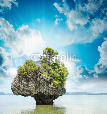Beautiful sunset over isolated rock in Thailand Sea