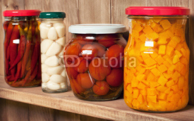 Fototapety Preserved  vegetable on shelf near a brown wooden wall