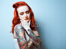 Fototapety Beautiful girl with stylish make-up and tattooed arms.