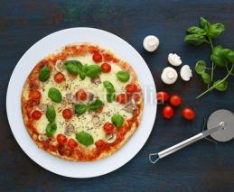 Pizza with mushrooms, tomatoes and basil