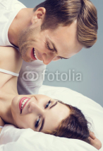 young attractive happy couple on the bed