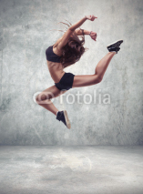 Fototapety young woman dancer with grunge wall background