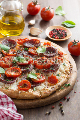Italian food - pizza with salami and tomatoes, vertical