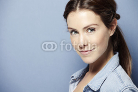 Fototapety Portrait of a young woman on a blue background