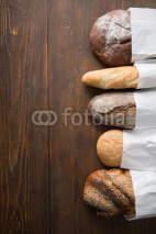 Fototapety Fresh baked bread at wooden table