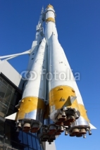 Three-stage space rocket against a blue sky