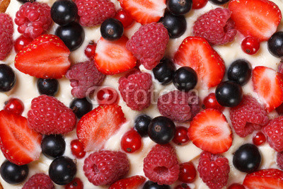 Background of strawberries, raspberries and currants with cream