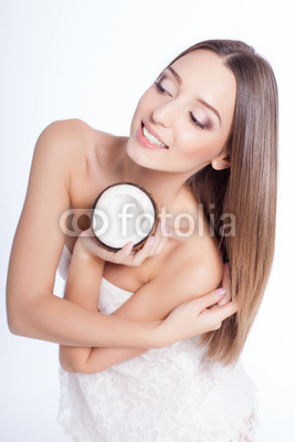 woman with perfect skin holding coconut over white background