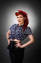 Naklejki Confident pin up girl posing with hands on waist
