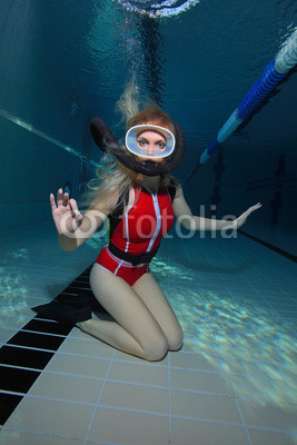 Female scuba diver with red swimsuit diving in the pool 