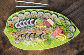 Naklejki Fresh sushi on green platter