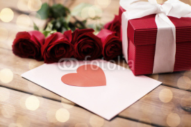 close up of gift box, red roses and greeting card