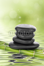Fototapety Zen basalt stones on bamboo in water
