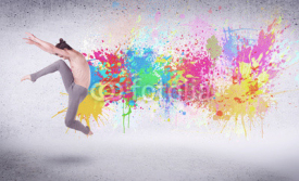 Obrazy i plakaty Modern street dancer jumping with colorful paint splashes